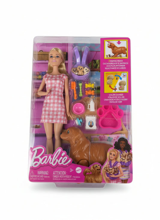 Barbie doll packaging with a dog and accessories on a gray surface