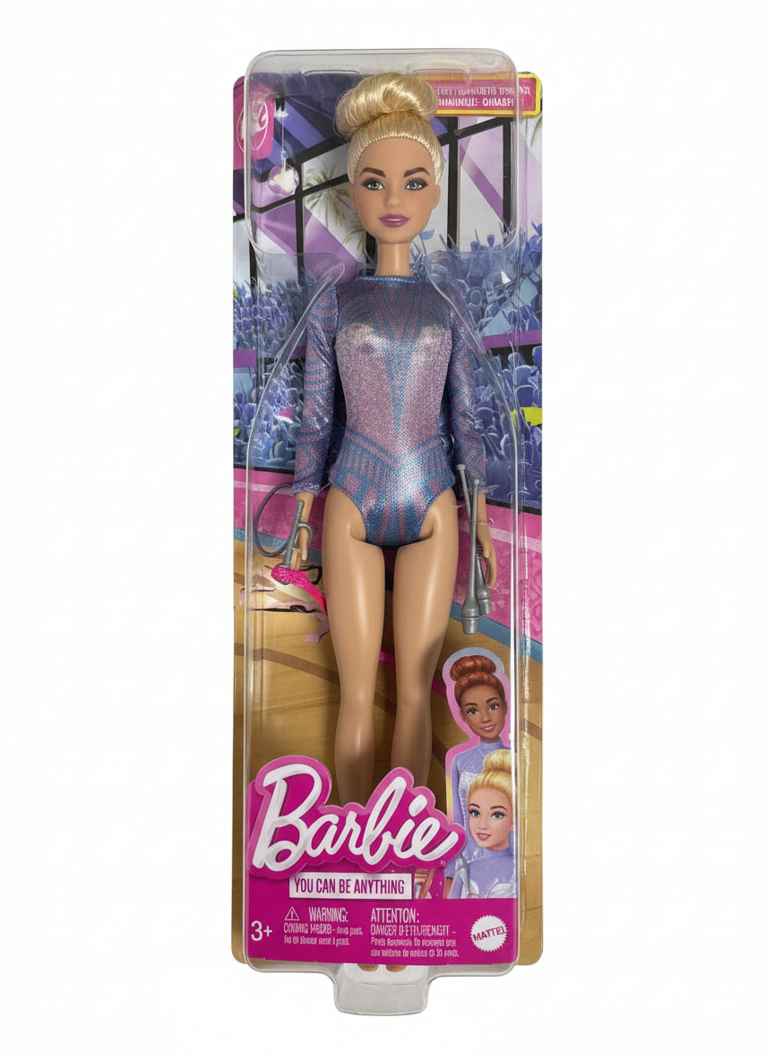 Barbie doll in a purple outfit with packaging on a chair
