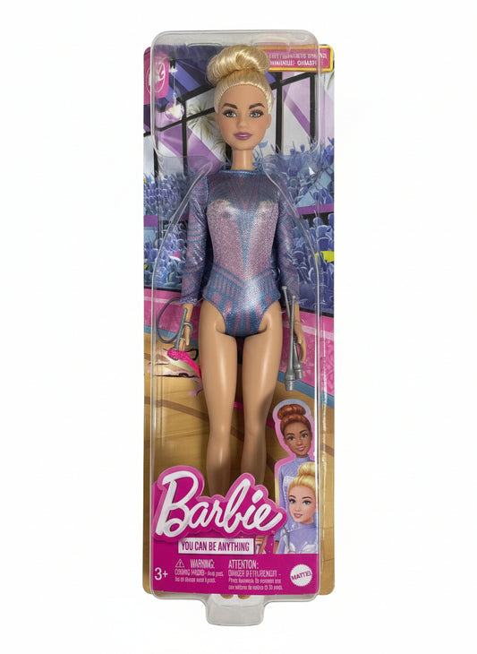 Barbie doll in a purple outfit with packaging on a chair