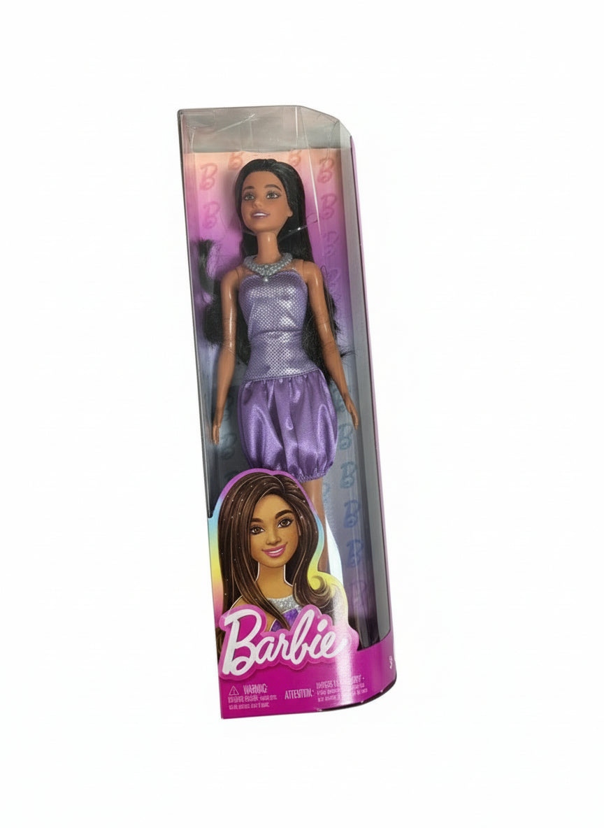 Barbie doll in packaging on a chair