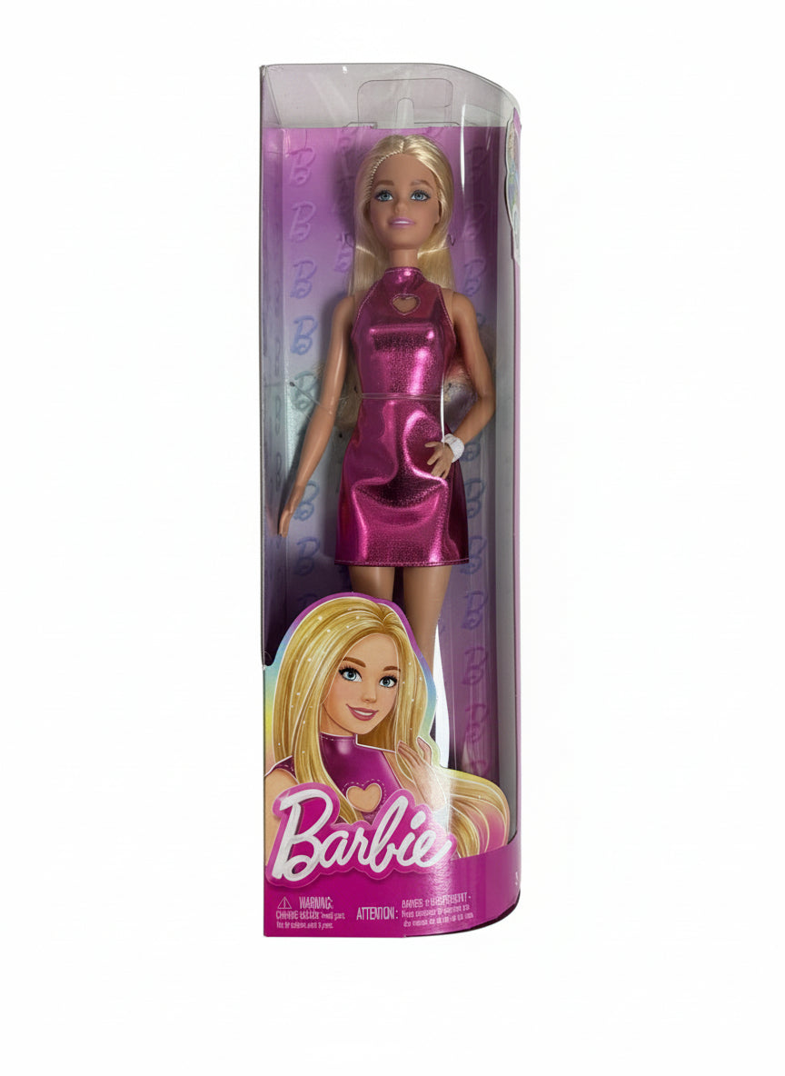 Barbie doll in a pink dress with packaging on a chair