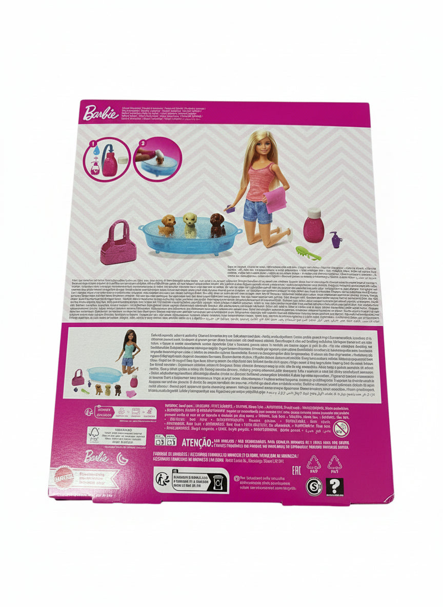 Barbie toy set packaging with illustrations of dolls and accessories on a gray surface